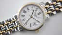 Close-up of the Tissot white dial with Roman numerals and date window.