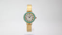 Front view of a gold-tone Yema ladies' watch with a turquoise cabochon bezel, silver dial, roman numerals, and a textured mesh bracelet.