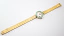 Overhead shot of the Yema watch laid flat, displaying the full length of the gold-tone mesh bracelet and the watch head.