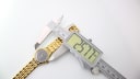 Digital caliper measuring the case diameter of the Tissot Stylist watch, displaying a measurement of 25.77mm.