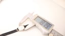 Digital caliper measuring the case diameter of the Bucherer watch, displaying a precise reading of 18.19mm.