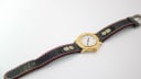 Extended view of the Michel Jordi watch and embroidered black leather strap, showcasing the edelweiss flower pattern.