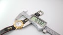 Digital caliper measuring the Michel Jordi watch case diameter as 32.08mm.