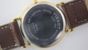 Close-up of the watch case back, detailing "TISSOT", "Stainless Steel", "Sapphire Crystal", "Water Resistant 30M", and model T870/970.