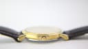 Close-up side profile of the Tissot watch, showing the crown and the case thickness.