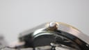 Close-up of the gold-plated fluted crown on the Certina watch.