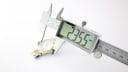 Digital caliper measuring the Certina watch case diameter at 23.55mm.
