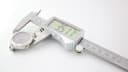 Close-up of a digital caliper measuring the case diameter of the Gucci watch, showing a reading of 39.17mm.