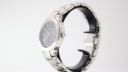 Side view of the Gucci 8900 M watch, showing the stainless steel case, integrated bracelet, and unsigned crown.