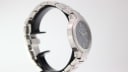 Three-quarter view of the Gucci 8900 M watch from the side, highlighting the polished and brushed finishes of the integrated stainless steel bracelet.