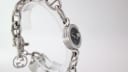 Another side angle of the G-Gucci watch, emphasising the G-shaped case and the stylish chain link bracelet.