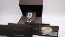 The Gucci 2305L watch with its original brown Gucci presentation box and warranty papers.