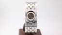 Full front view of the Gucci T.1.2 watch on a stand, showcasing the integrated 'GG' monogram bangle bracelet.