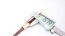 Digital caliper measuring the lug width of the Raymond Weil 310 watch, showing a reading of 15.14mm.