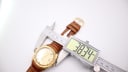 Digital caliper measuring the case diameter of the Royce Leadership 1100 watch at 38.34mm.