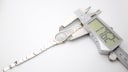 Digital caliper measuring the case width of the Tissot Stylist watch at 17.62mm.