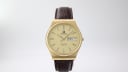 Front view of the Tissot Seastar Quartz watch, featuring a champagne dial with gold baton indices and day/date display, set in a distinctive octagonal gold case on a brown leather strap.