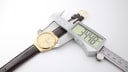 Digital calipers measuring the Tissot Seastar Quartz case, showing a diameter of 34.88mm.