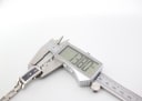 Digital caliper measuring the case thickness of the Gucci 110 watch, displaying a reading of 13.80 mm.