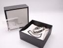 The Gucci 110 watch displayed within its original black Gucci presentation box, with a branded cloth and plastic pouch.
