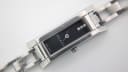 Detailed close-up of the black rectangular dial of the Gucci 110, featuring three small stone markers, "GUCCI" logo, and "SWISS MADE" text.