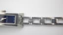 Another close-up of the stainless steel bracelet, displaying the 'GUCCI' engraving on a link.