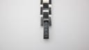 Close-up of the signed deployment clasp of the stainless steel bracelet, with 'GUCCI' engraved vertically.