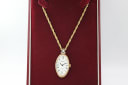 Top-down view of the vintage Seiko pendant watch in its original red presentation box, slightly different angle.