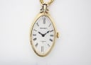 Front view of the gold-tone oval Seiko pendant watch dial, showing 'SEIKO' and '17 JEWELS'.