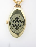 Close-up of the polished gold-tone case back with a decorative emblem and model number 21-7190.