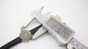 Digital caliper measuring the case diameter of the Amara watch at 23.04mm.