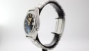 Side profile view of the watch on a stand, highlighting the case shape and crown.
