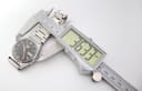 Digital caliper measuring the case diameter of the watch, showing a precise reading of 36.37mm.