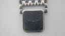 Close-up of the fold-over clasp of the Longines Flagship's steel bracelet, showing the faint Longines logo and surface scratches.