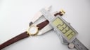 Digital caliper measuring the case diameter of the Solvil et Titus watch as 23.7mm.