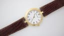 Close-up front view of Solvil et Titus Sonville white dial with black roman numerals and gold-tone hands.