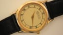 Close-up front view of Rodania 18711 quartz watch with champagne wave-textured dial and Roman numerals.