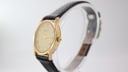 Angled side view of the Rodania 18711 gold-plated case and crown, showing signs of wear on the plating.