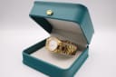 Angled view of the gold tone Certina DS watch sitting in a green studio presentation box.