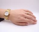 Certina DS gold tone watch worn on a wrist, showing the integrated bracelet and dial.