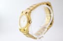 Side profile view of the Certina DS gold tone watch on a clear stand, highlighting the case shape and crown.