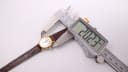 Digital caliper measuring the Tissot Seastar's case diameter at 20.23mm.