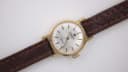 Elevated view of the Tissot Seastar watch, showing the dial and brown leather strap.