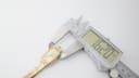 Digital caliper measuring the width of the Seiko 11-4860 rectangular case, showing 16.20mm.