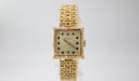 Front view of Caravelle N.1 vintage gold tone square watch with textured cream dial and black indices.