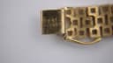Close-up of the watch bracelet's fold-over clasp, showing "PAT 3308517" engraving.