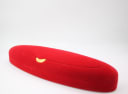 The closed red velvet presentation box, viewed from an angled perspective.