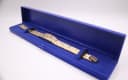 Gold-toned Seiko watch resting inside a generic blue presentation box.