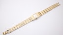 Top-down view of the gold-toned Seiko watch with its textured bracelet fully extended.