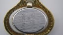 Case back of the Oris pendant watch, engraved with 'MARGARET 20-4 JM 75' and 'STAINLESS STEEL BACK SWISS'.